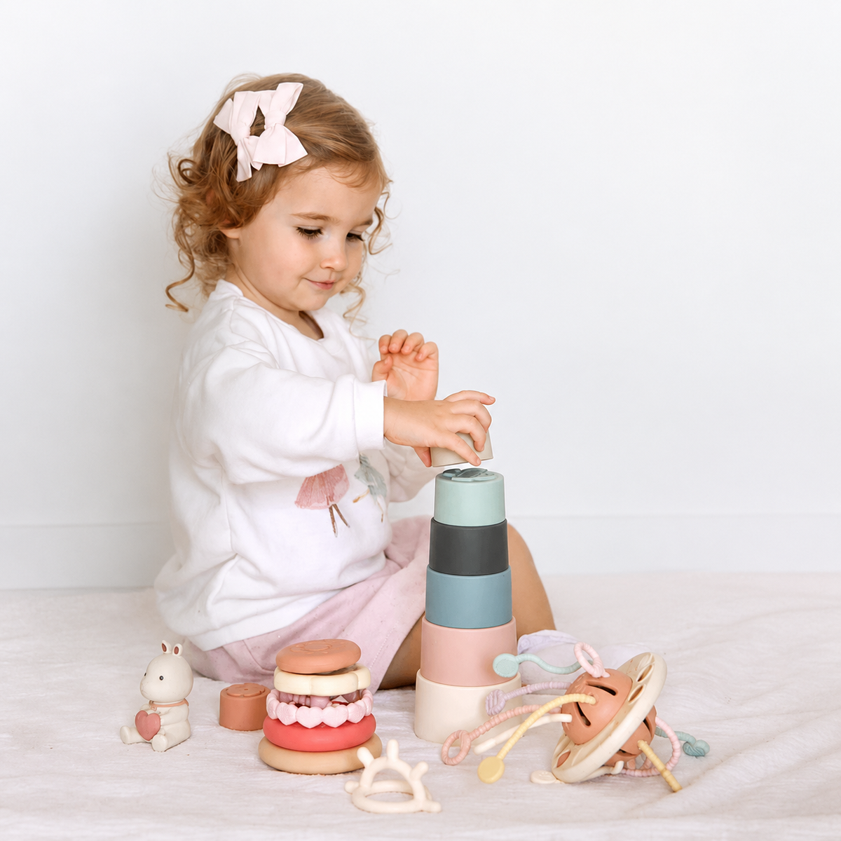 Nestwell Baby Deluxe Playtime Gift Set in blush bloom with silicone UFO pulling toy
